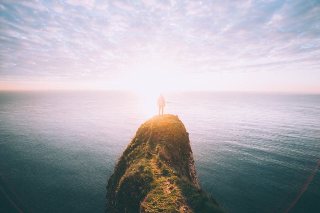 man standing on a rock by himself